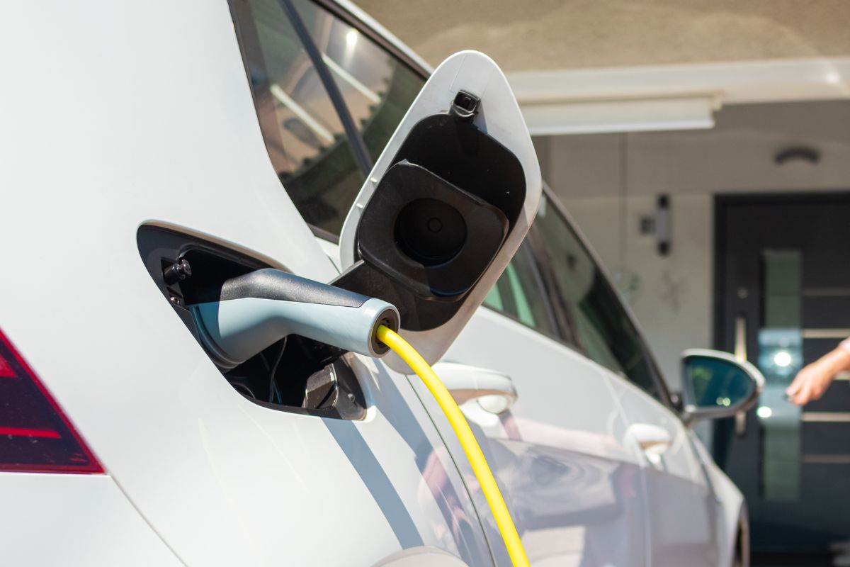 EV vehicle plugged in and charging on home driveway